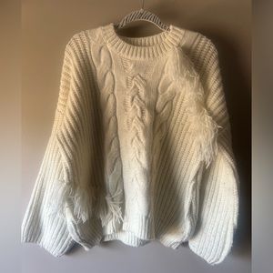 White chunky/oversized sweater with frills.